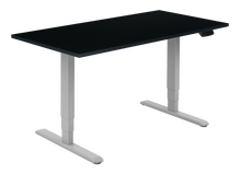 Load image into Gallery viewer, Height adjustable desk with black top and silver frame. Electrically operated, ideal for working from home

