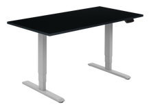 Load image into Gallery viewer, Height adjustable desk with black top and silver frame. Electrically operated, ideal for working from home